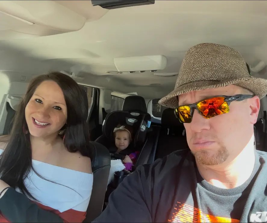 Travis Boles riding in a car with family