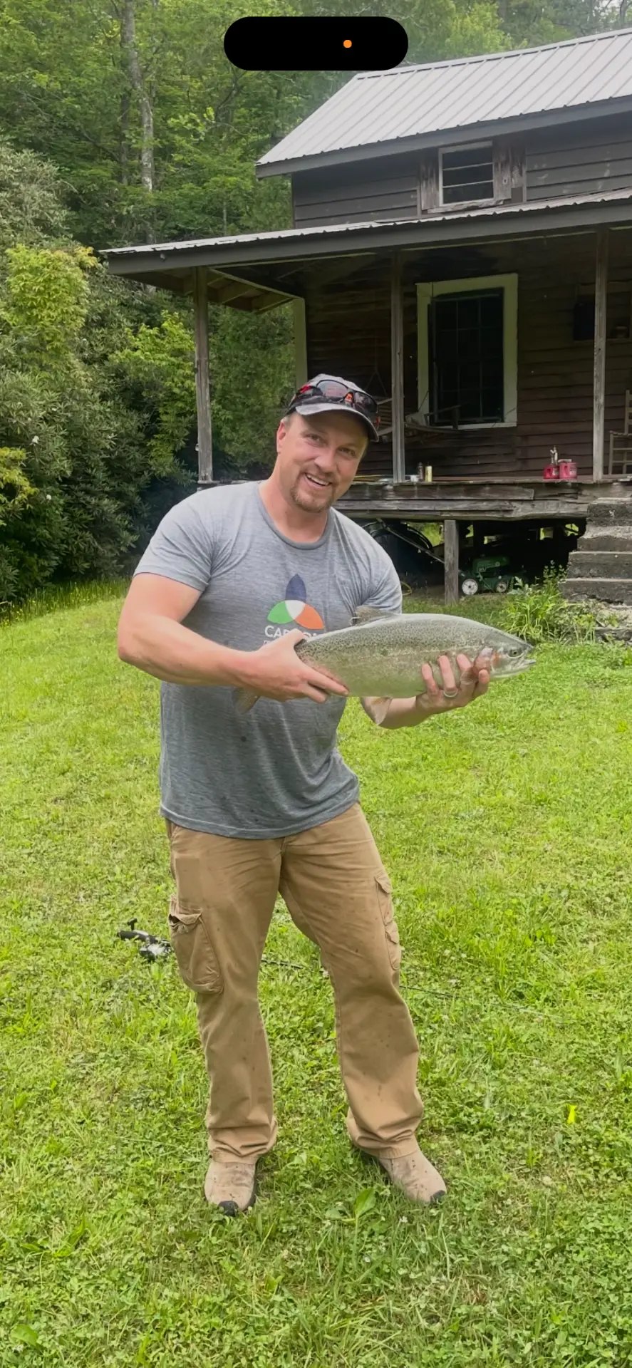 Travis Boles holding a fish he caught