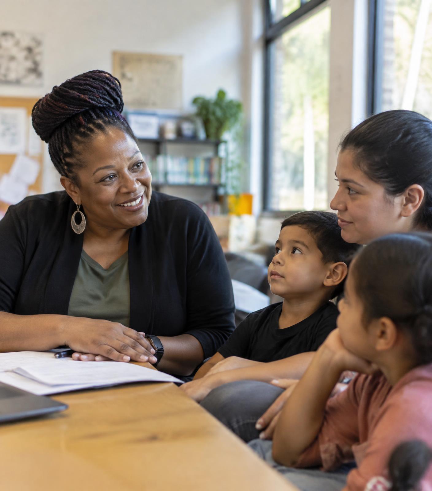 A community leader listening to a family at a neighborhood resource center